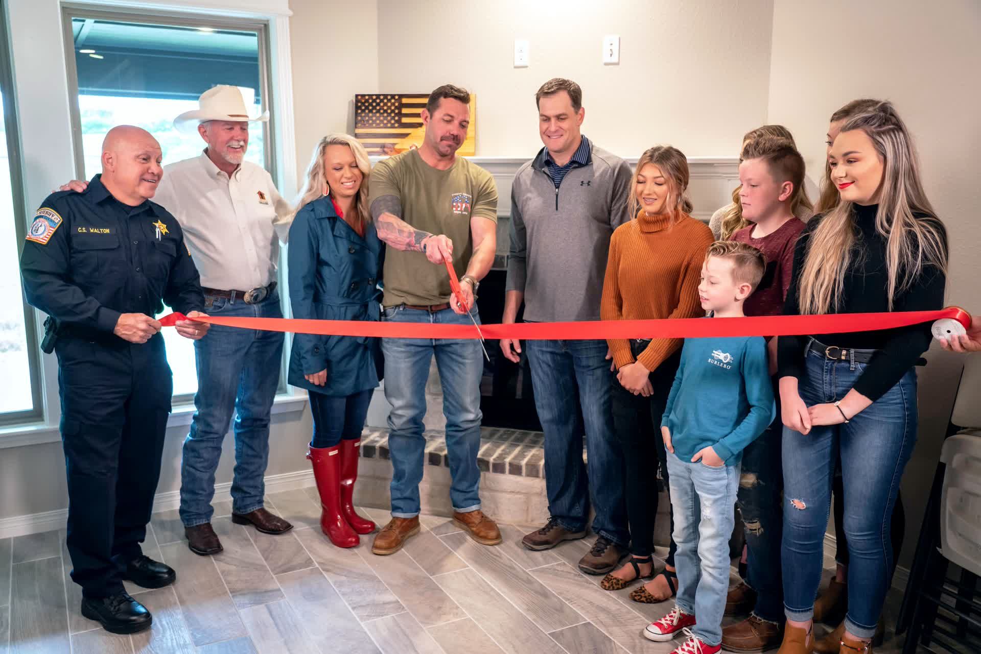 a group of people at a ribbon cutting ceremony
