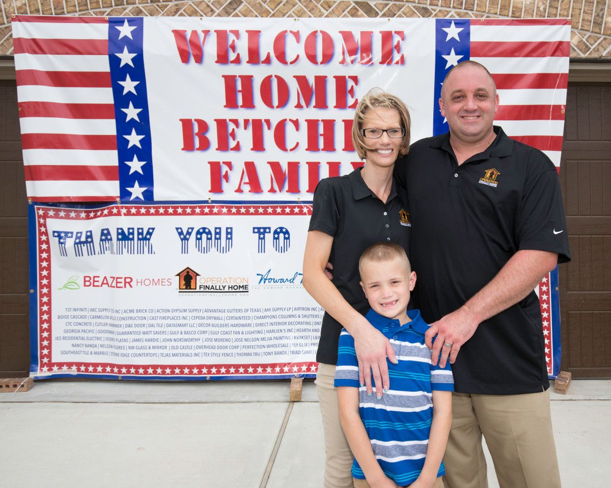 the betcher family posing in front of their new home