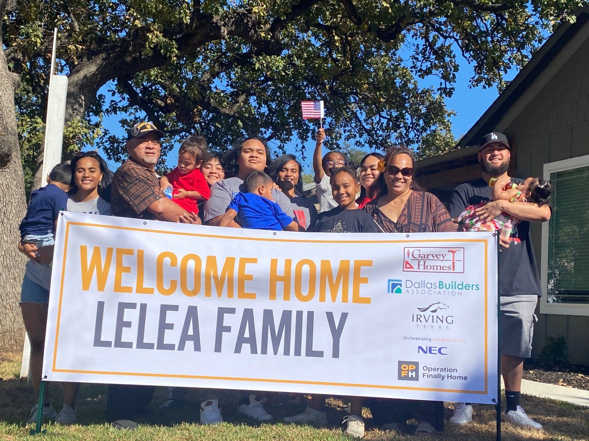 the lelea family standing in front of their home